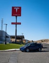 A Tesla sedan arrives for charging at a Tesla Supercharger station in Kettleman City, California Royalty Free Stock Photo