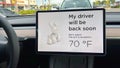 A Tesla set on dog mode to keep the air conditioning on for the car owners canine companion while they are parked in a parking lot Royalty Free Stock Photo