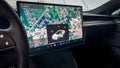 Tesla touchscreen interface displaying detailed map and vehicle controls Royalty Free Stock Photo