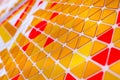 tessellation of a plane with yellow, orange and red colored triangles on a white background. mathematical and artistic game to co