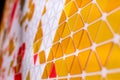 tessellation of a plane with yellow, orange and red colored triangles on a white background. mathematical and artistic game to co