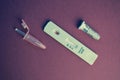 Test for coronavirus on a purple background. on a matte background a sensitive strip for coronavirus, a pink lancet and a