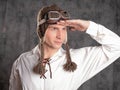 test pilot, a dreamer. young man in a funny knitted earflaps and flight glasses,