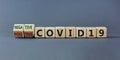 Test result of a Corona test. Turned cubes and changed words `positive COVID19` to `negative COVID19`. Beautiful grey backgrou