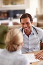 The test results show that everything is fine. a male doctor talking to a female patient in his office. Royalty Free Stock Photo