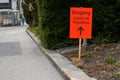 Test station Covid-19 signpost in German in orange color showing with arrow the direction to the testing center Royalty Free Stock Photo