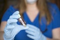Test tube in hand of lab technician with sample of coronavirus covid-19 Royalty Free Stock Photo