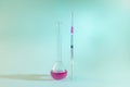 A test tube and a syringe isolated. Science and cure concept