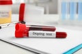 Test tubes with blood samples on white table. Doping control Royalty Free Stock Photo