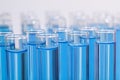 Test tubes with blue reagents on background, closeup. Laboratory analysis
