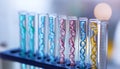 Test tubes with different illustrations of DNA in laboratory, closeup Royalty Free Stock Photo