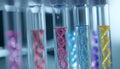 Test tubes with different illustrations of DNA in laboratory, closeup Royalty Free Stock Photo