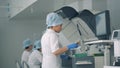 Test tubes are getting relocated into biochemical analyzer by a laboratory worker