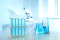 Test tubes with light blue liquid on table in laboratory. Space for text Royalty Free Stock Photo