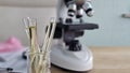 Test tubes and microscope on laboratory table during science experiment Royalty Free Stock Photo