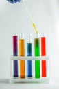 Test tubes with multi-colored reagents on a white background. chemistry Royalty Free Stock Photo