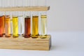 test tubes with oil blends on a wooden stand