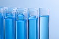 Test tubes with reagents on blue background, closeup. Laboratory analysis