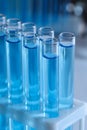 Test tubes with reagents in rack against blurred background, closeup. Laboratory analysis Royalty Free Stock Photo