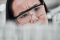 Test tubes, scientist and confused woman closeup with investigation, thinking and science research. Laboratory, clinic