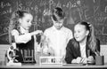 Test tubes with substances. Formal education. Girls and boy student conduct school experiment with liquids. School