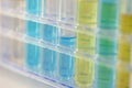 Test tubes with yellow and blue reagent, shallow focus