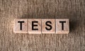 Test word made of wood background. Business concept. Test sign, exam, learning concept. Word test written with wooden cubes.