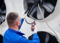 Testing with an anemometer of an axial fan of the condensing unit Royalty Free Stock Photo