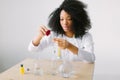 Testing blood samples. Top view of young female scientist examining blood while working in the laboratory Royalty Free Stock Photo