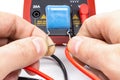 Testing capacitor with multimeter on a white background Royalty Free Stock Photo