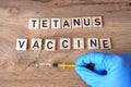 Tetanus vaccine concept. Hand in gloves is taking syringe