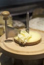 Tete de moine raw milk cheese with girolle on cutting board