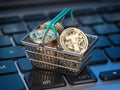 Tether coins in shopping basket on laptop keyboard. Tether wallet and payment