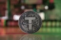 Tether USDT crypto coin placed on reflective surface with microscheme in the background and lit with red and green lights. Royalty Free Stock Photo