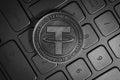 Tether USDT Cryptocurrency physical coin placed on computer keyboard