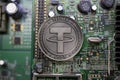 Tether USDT cryptocurrency physical coin placed on computer micro sheme