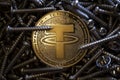 TETHER USDT cryptocurrency physical coin placed between metal screws. Royalty Free Stock Photo