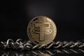 Tether USDT cryptocurrency physical coin placed next to metal chain on reflective surface in the black background