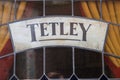 Tetley beer alcoholic drink brand stained glass window showing company logo and branding in pub window