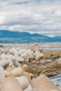 Tetrapod breakwater leading to concrete pier