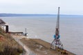 Tetyushi, Tatarstan / Russia - May 2, 2019: Top view of the empty industrial pier with cargo ship-lifting crane on the dock along Royalty Free Stock Photo