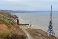 Tetyushi, Tatarstan / Russia - May 2, 2019: Top view of the empty industrial pier with cargo ship-lifting crane on the dock along Royalty Free Stock Photo