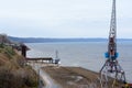 Tetyushi, Tatarstan / Russia - May 2, 2019: Top view of the empty industrial pier with cargo ship-lifting crane on the dock along Royalty Free Stock Photo