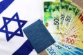 Teudat Zehut Israeli passport on the flag of Israel and Israeli shekel. Israeli citizen, economy in Israel, business in Israel