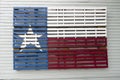 Texas flag painted on wooden pallet and hung on building wall. Royalty Free Stock Photo