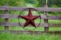 Texas rustic star on countryside side wooden fence, with road to the house slowly dissolving in the background. Royalty Free Stock Photo