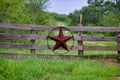 Texas rustic star on countryside side wooden fence, with road to the house slowly dissolving in the background. Royalty Free Stock Photo