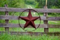 Texas rustic star on countryside side wooden fence, with road to the house slowly dissolving in the background. Royalty Free Stock Photo