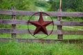 Texas rustic star on countryside side wooden fence, with road to the house slowly dissolving in the background. Royalty Free Stock Photo