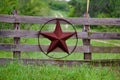 Texas rustic star on countryside side wooden fence, with road to the house slowly dissolving in the background. Royalty Free Stock Photo